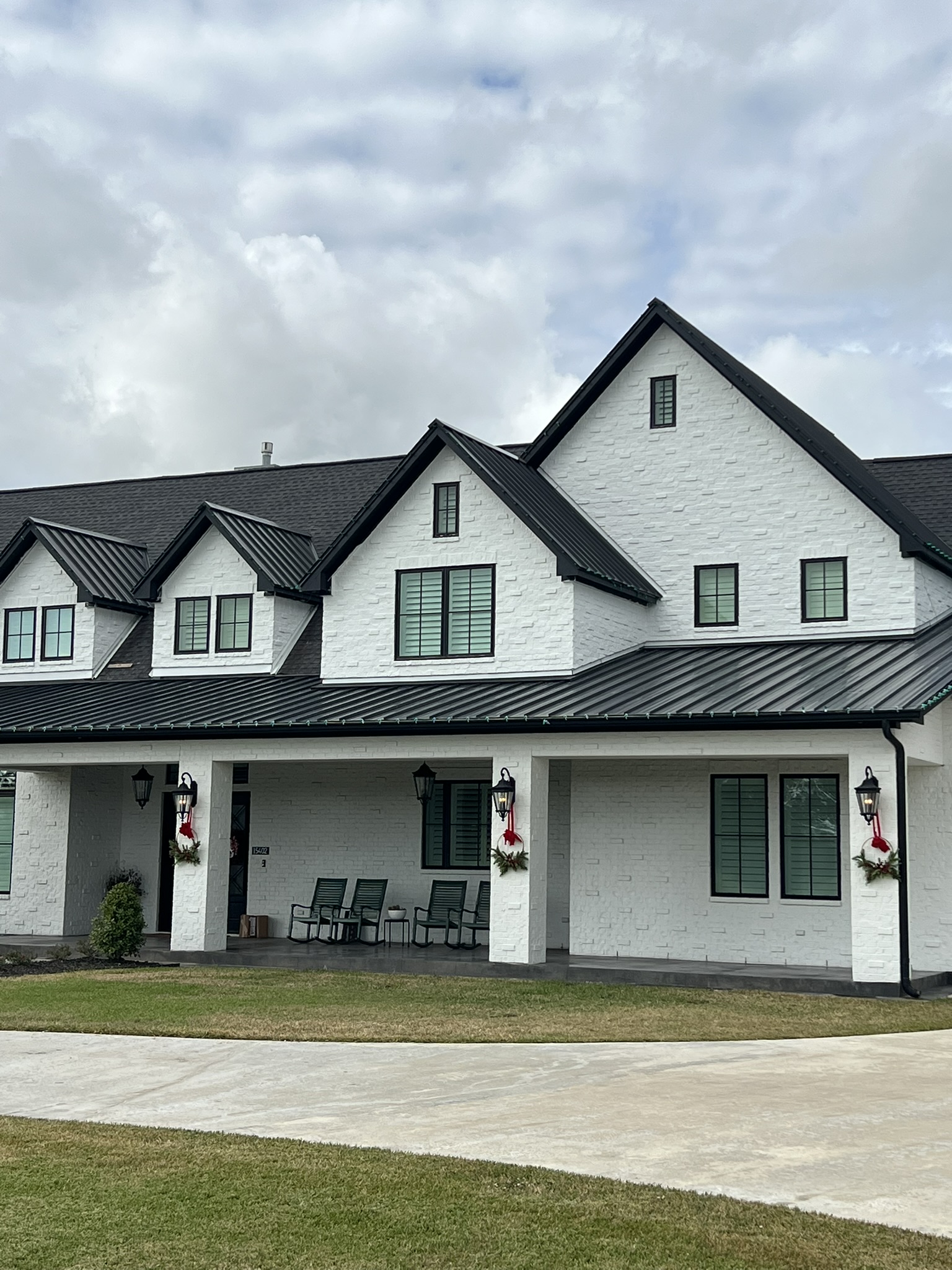 A Hawk Roofing project — a custom home with standing seam metal roofing in the Houston area
